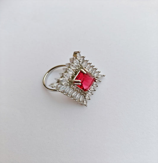 Silver-toned American Diamond Ring with a Square cut Red Stone in the center.