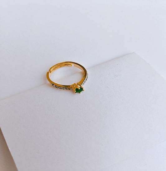 Elegant Gold-toned American Diamond Ring with Emerald Green Gemstone as Centerpiece