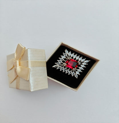 Silver-toned American Diamond Ring with a Square cut Red Stone in the center.