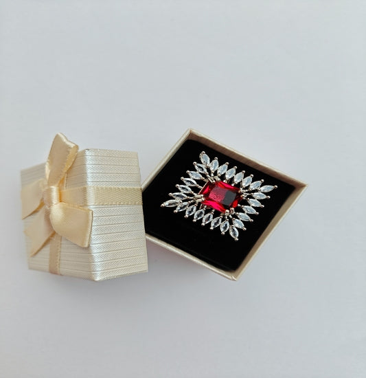 Silver-toned American Diamond Ring with a Square cut Red Stone in the center.