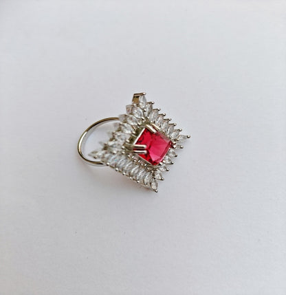 Silver-toned American Diamond Ring with a Square cut Red Stone in the center.