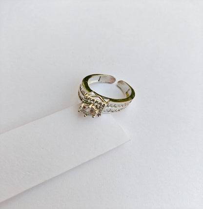 Silver-Toned American Diamond Solitaire Ring with Sparkling Side Stones